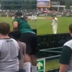 Nathan Lyon reacts as a South African fan waves sandpaper during the Australia vs South Africa third Test at Newlands in Cape Town.