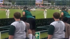 Nathan Lyon reacts as a South African fan waves sandpaper during the Australia vs South Africa third Test at Newlands in Cape Town.